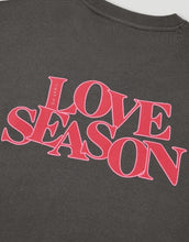 Laden Sie das Bild in den Galerie-Viewer, Light Love Season Sweater von OH APRIL in Graphite mit großem Love-Season-Print auf dem Rücken und kleinem Logo auf der Brust, entspannte Passform, leicht verkürzt, aus weichem Baumwollmix mit klassischem Rundhalsausschnitt.