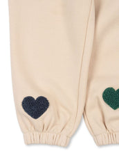 Laden Sie das Bild in den Galerie-Viewer, Beige-rosefarbene Lou Sweatpants von Konges Sløjd mit bunten Herzen und elastischem Bund.