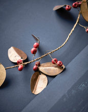 Laden Sie das Bild in den Galerie-Viewer, House Doctor Kranz Auric ø12 cm – handgemachter goldener Messingkranz mit roten Mangoholzperlen.