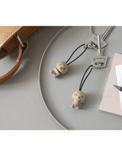 Laden Sie das Bild in den Galerie-Viewer, Hoptimist® Schlüsselanhänger Bumble Eiche braun – FSC®-zertifizierter Holz-Anhänger mit fröhlichem Hoptimist-Design.

