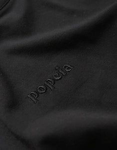 Schwarzes Langarmshirt von Popeia aus 100 % Bio-Baumwolle mit Relaxed Fit, breitem Kragen und Kindness-Spruch im Nacken.
