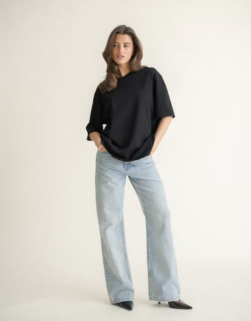 Schwarzes Oversize T-Shirt von Gina Tricot mit langer Passform, kurzen Ärmeln und Rundhalsausschnitt.
