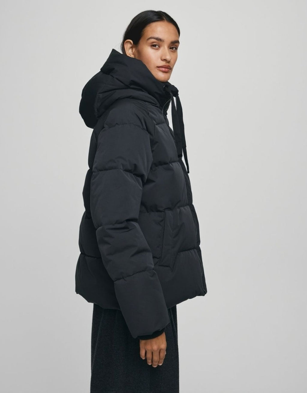 Schwarze kurze Winterjacke Pavinaria Short von MSCH Copenhagen mit Kapuze, hohem Kragen, leichter Wattierung und seitlichen Reißverschlüssen.