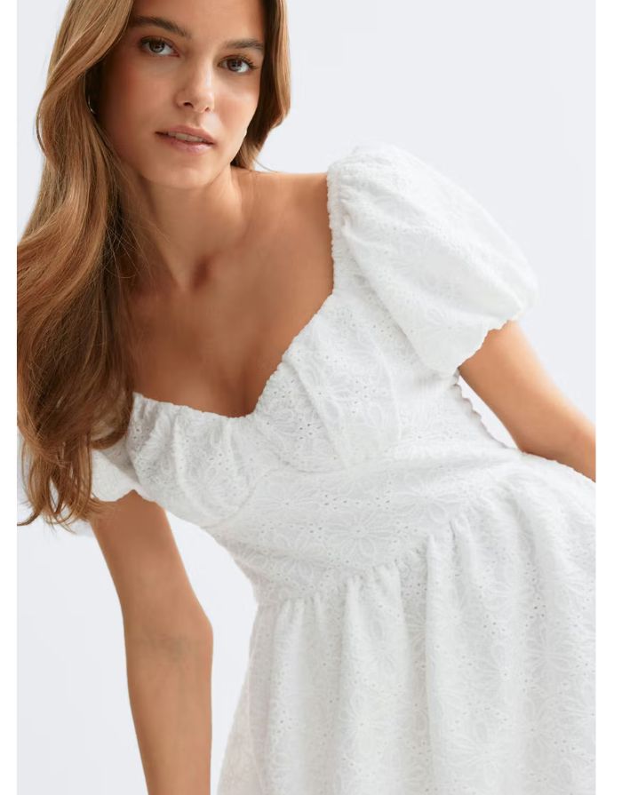 Gina Tricot weißes Kleid mit Puffärmeln, gestickten Details und definierter Taille an Model im Detail