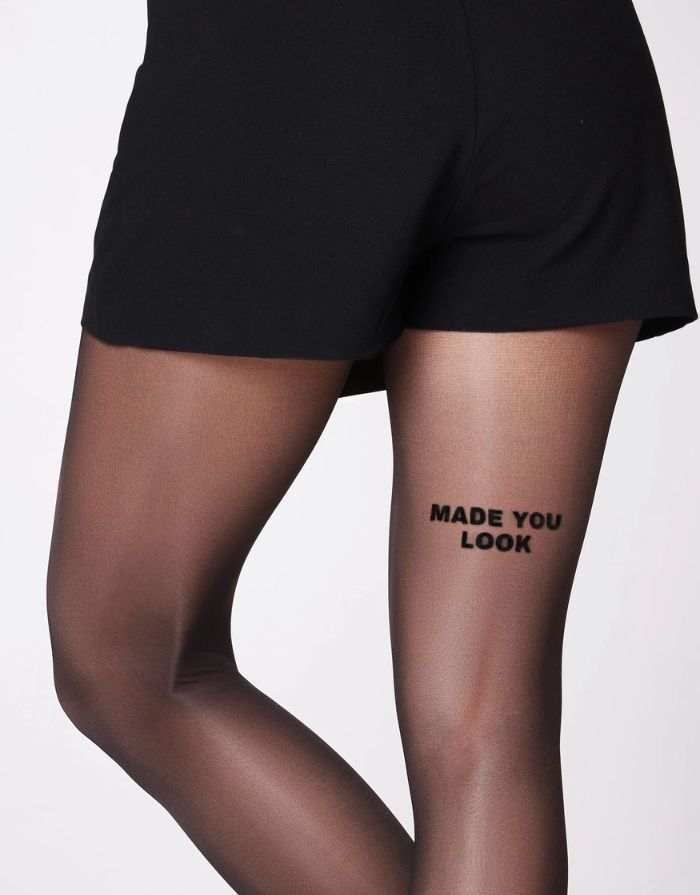 Schwarze semi-transparente Statement-Strumpfhose Made You Look von saint sass mit 40 DEN und Schriftzug am rechten hinteren Oberschenkel.