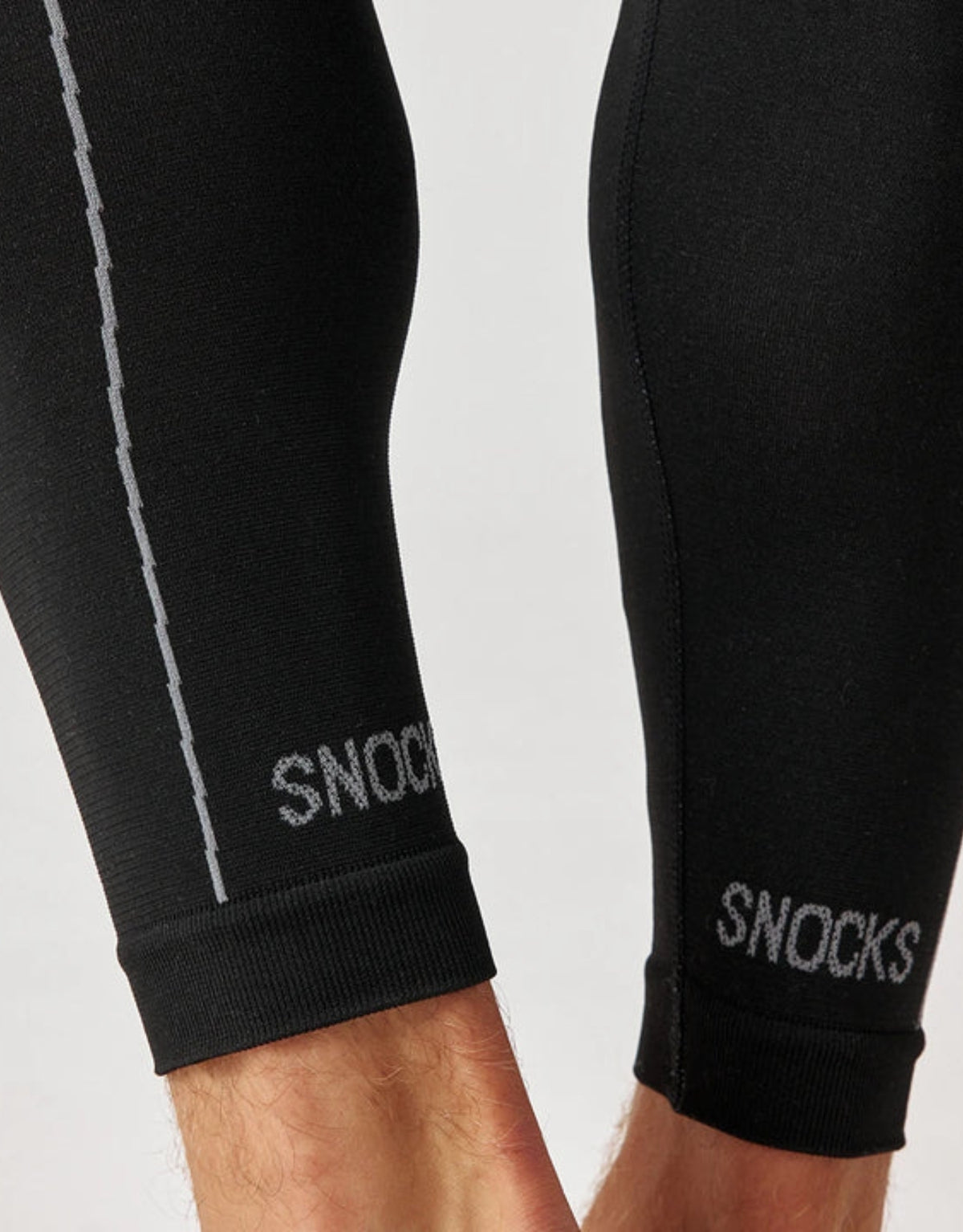 Schwarze Thermounterhose für Herren von SNOCKS aus elastischem, recyceltem Funktionsmaterial mit körpernaher Passform für angenehme Wärme an kalten Tagen,  Bündchen am Knöchel mit Schriftzug.