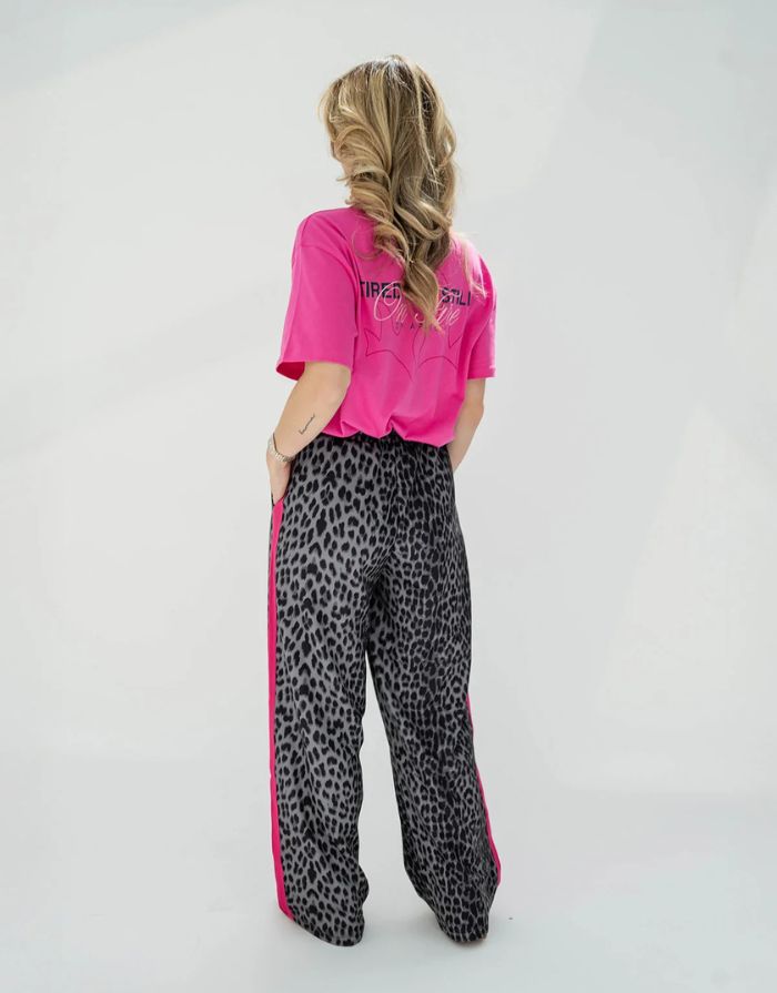 OH APRIL Trackpants Kael Leo Grey – weite Damenhose mit rosa Seitenstreifen, Leo-Muster, Wide Leg Fit, Größen XS–XL.