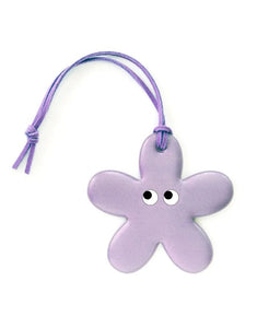 Blumenförmiger Reflektor-Anhänger Flower Lilac von Firefly Reflectors in Flieder aus reflektierendem Material mit Lederband, ca. 8 cm – dekorativ und funktional.
