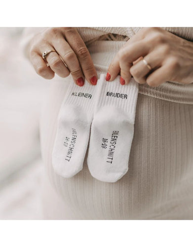 Babysocken Kleiner Bruder von Eulenschnitt, 80% Baumwolle, 18% Polyamid, 2% Elastan, mit Schriftzug „Kleiner Bruder“ auf dem Bündchen.