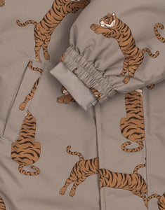 Hellbrauner Schneeeinteiler mit Tigermuster von Konges Sløjd, wasser- und winddicht, mit abnehmbarer Kapuze und Handschuhhaken.